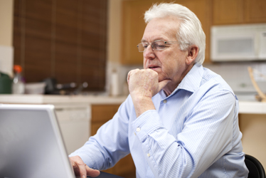 man looking at his computer